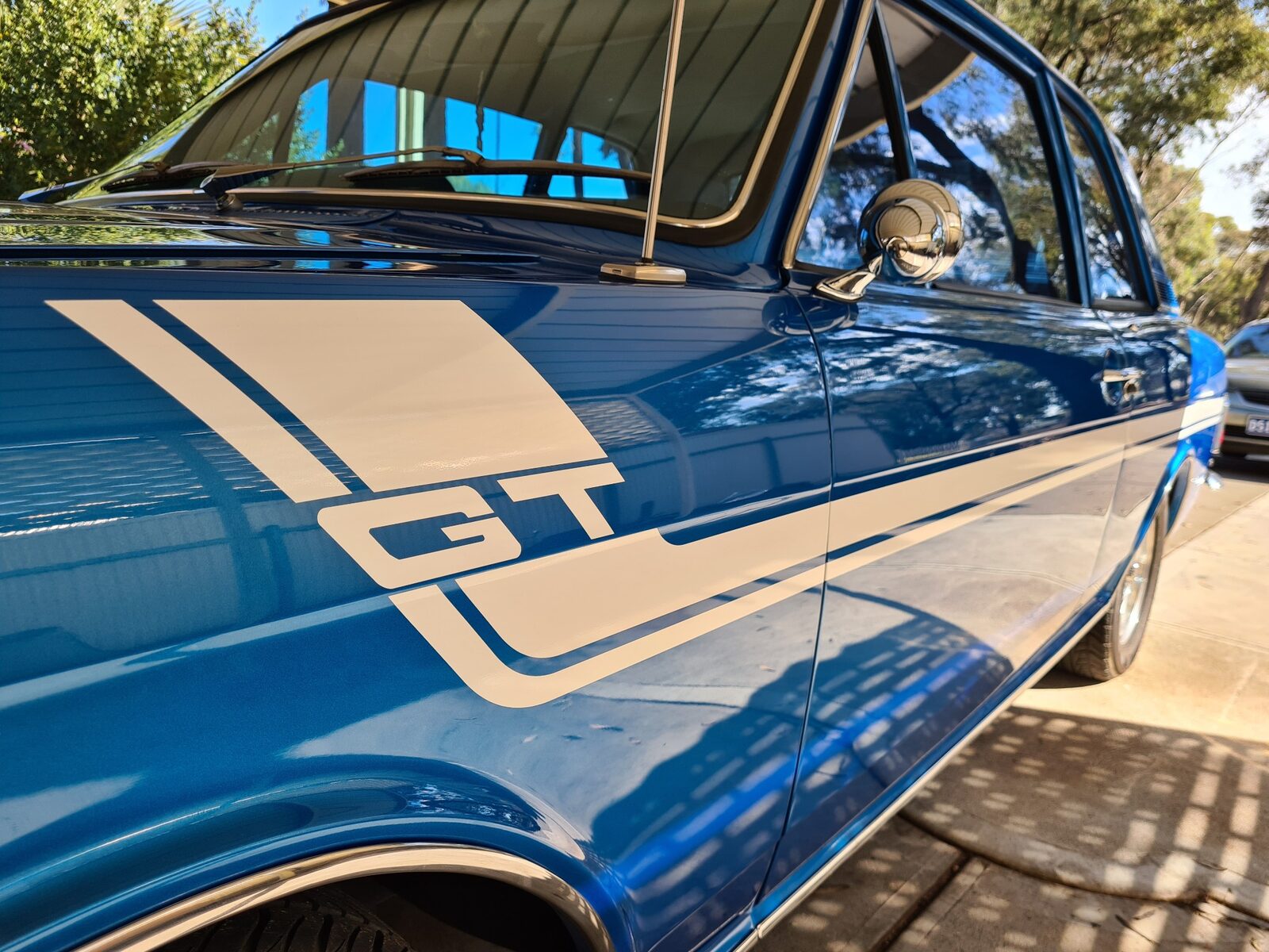 Blue classic car with white custom GT decals