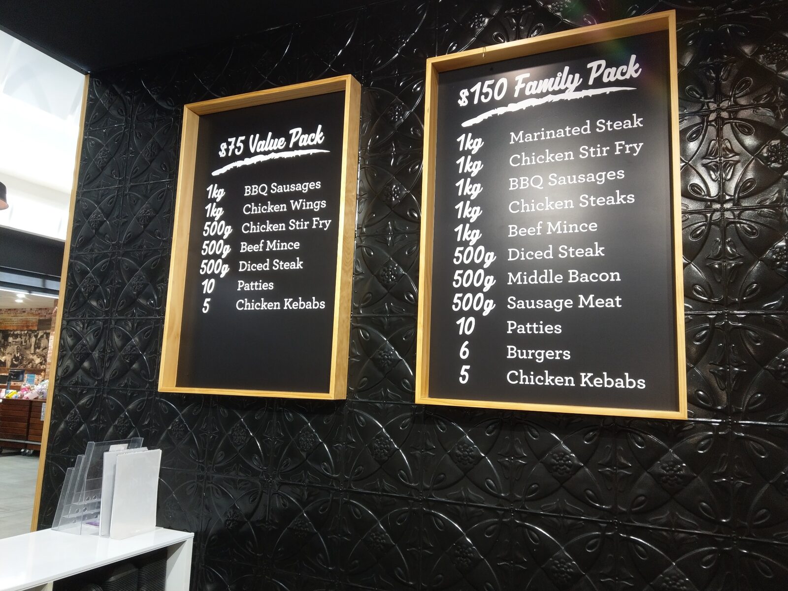 Two framed black indoor menu boards