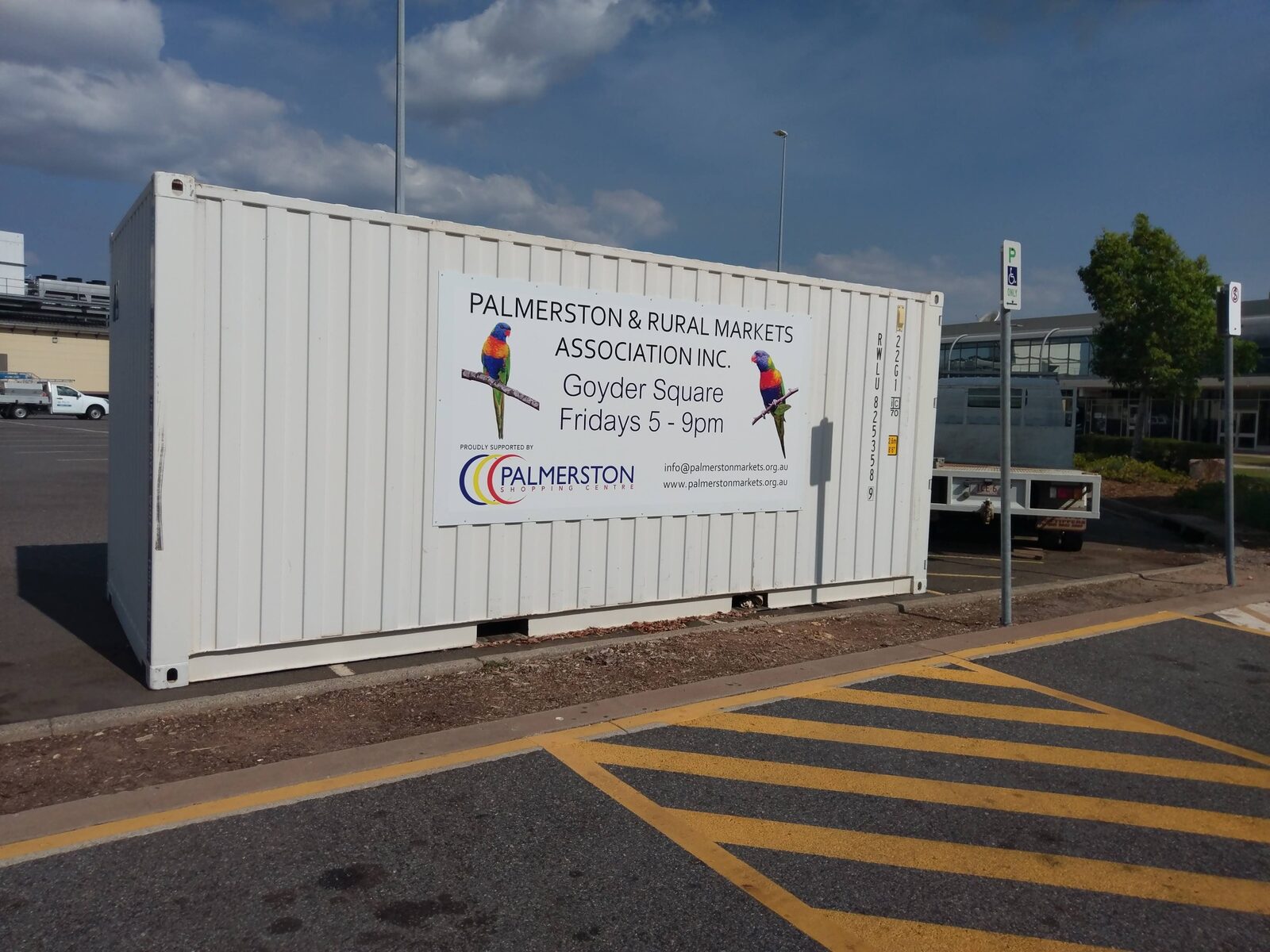 Large market panel sign mounted to a shipping container