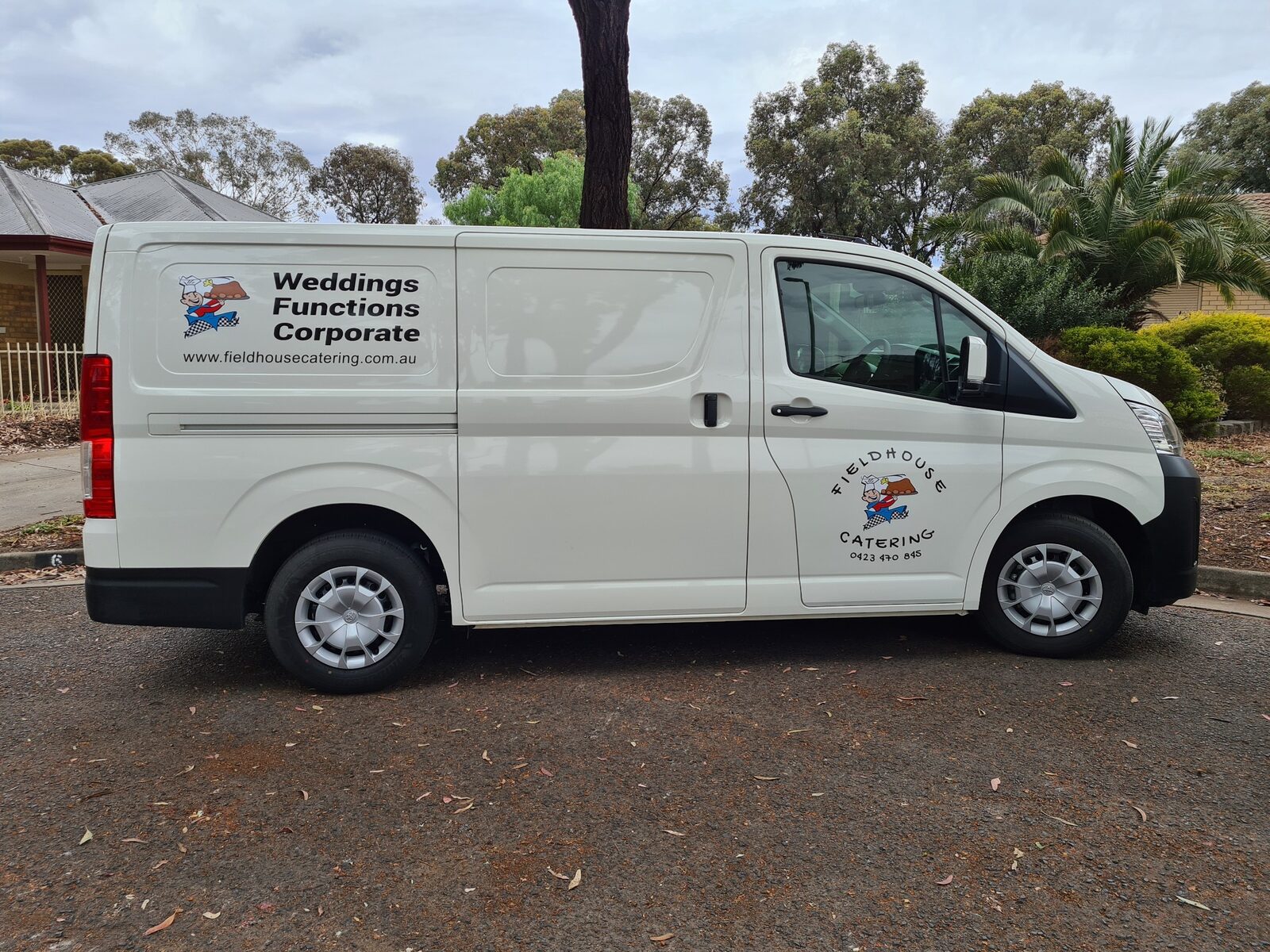 White catering van with business signage